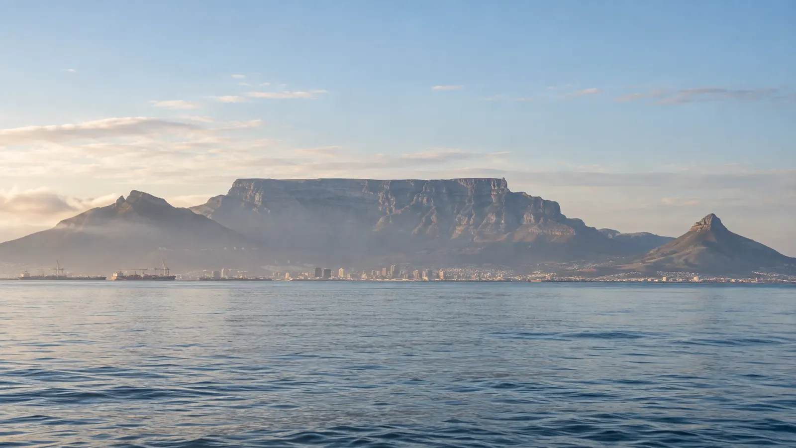 Cape Town's Table Mountain silhouette across Table Bay in an illustrative coastal photograph.